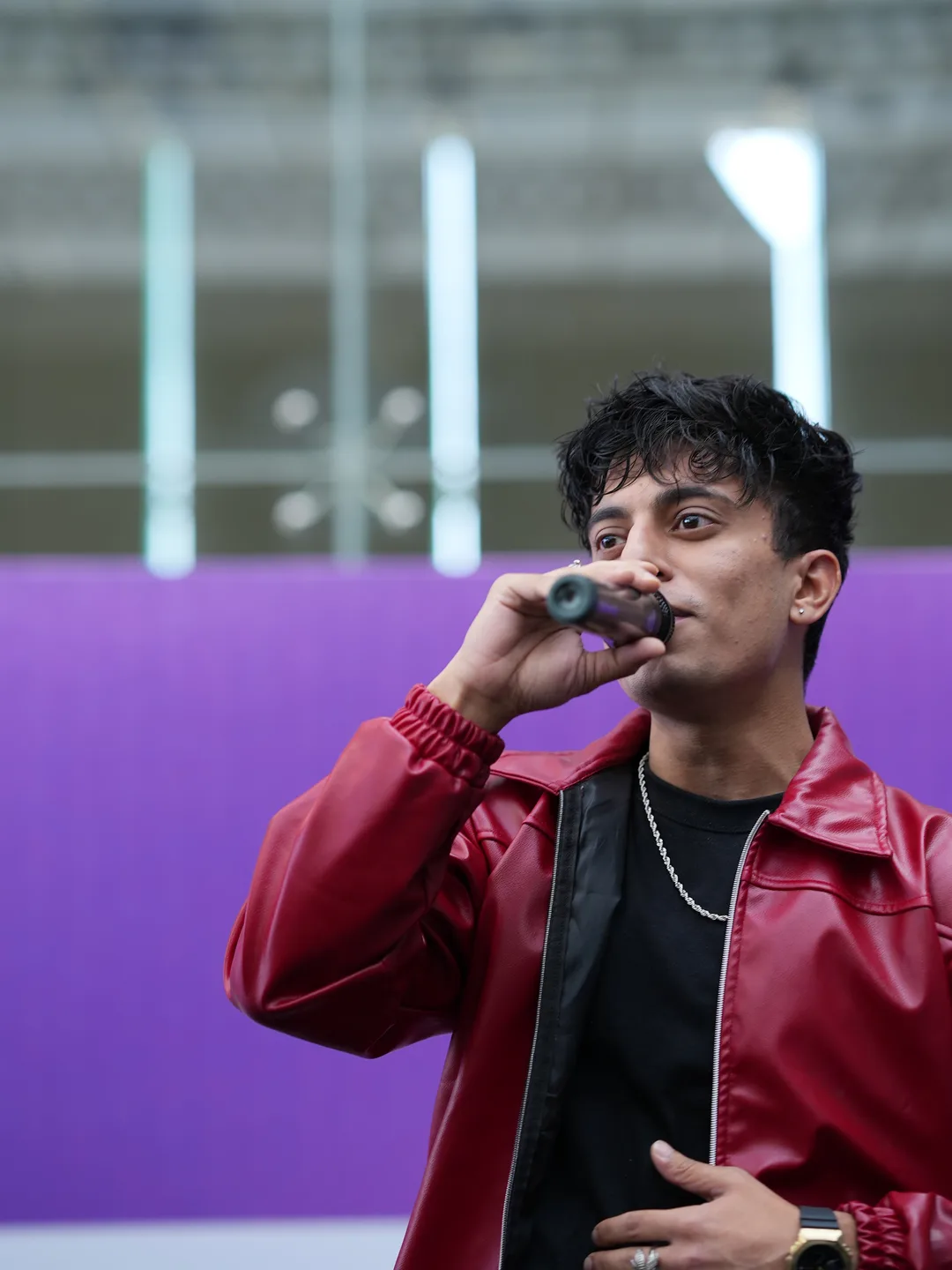 Flux launch event — vocalist on the purple-lit stage